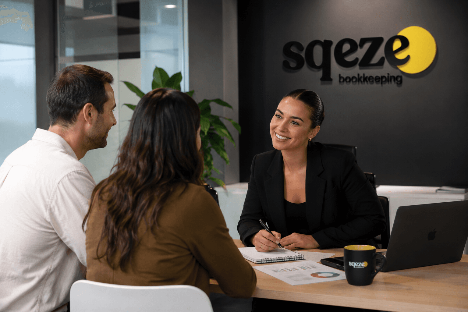 A SQEZE bookkeeper meeting with two clients in the SQEZE office